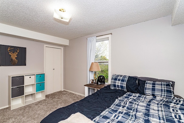 bedroom featuring a textured ceiling and carpet floors