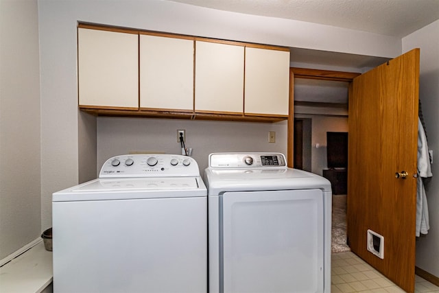 washroom featuring cabinet space and washing machine and clothes dryer