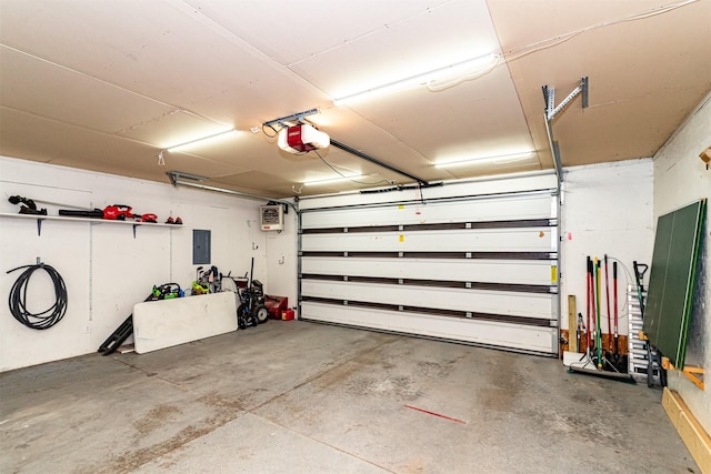 garage featuring electric panel and a garage door opener