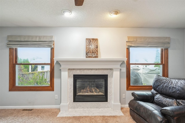 carpeted living area with a fireplace and baseboards