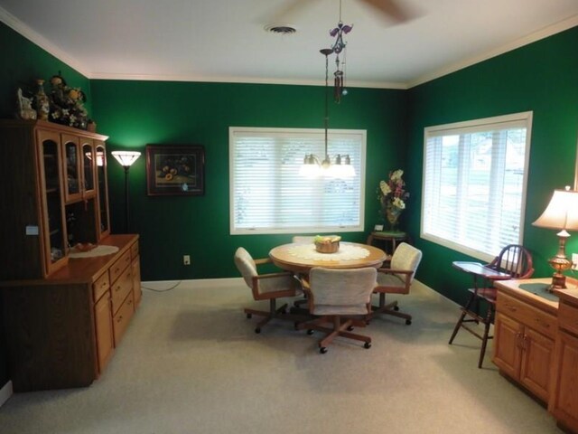 322 S Temple St, Osceola, IA 50213 - dining space featuring ornamental molding, light carpet, and a ceiling fan