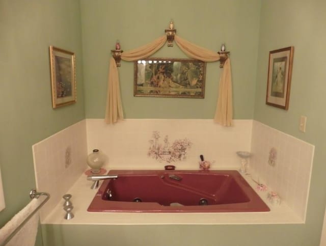 bathroom with a tub with jets