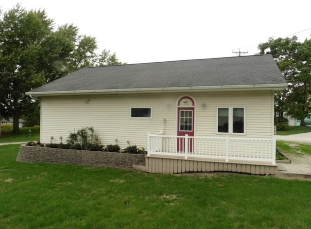 rear view of property with a lawn