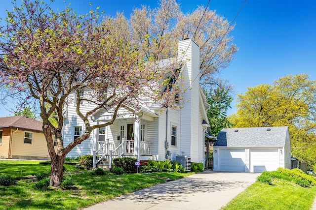 2620 35th St, Des Moines, IA 50310 - view of front of home with central AC unit, a front yard, a chimney, and a garage