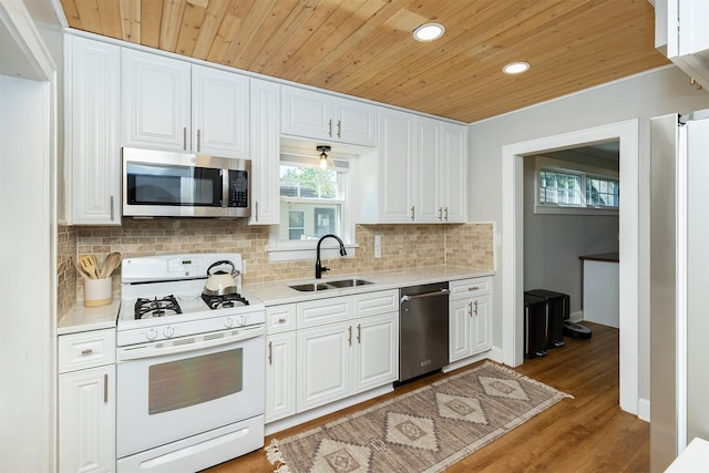 2620 35th St, Des Moines, IA 50310 - kitchen with appliances with stainless steel finishes, a sink, wood ceiling, light countertops, and tasteful backsplash