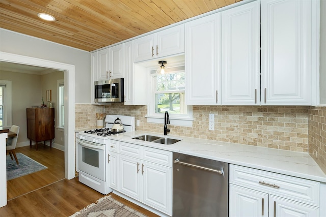 2620 35th St, Des Moines, IA 50310 - kitchen with appliances with stainless steel finishes, a sink, white cabinetry, dark wood-type flooring, and wood ceiling