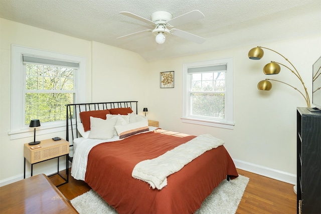 2620 35th St, Des Moines, IA 50310 - bedroom with wood finished floors, baseboards, a textured ceiling, and a ceiling fan