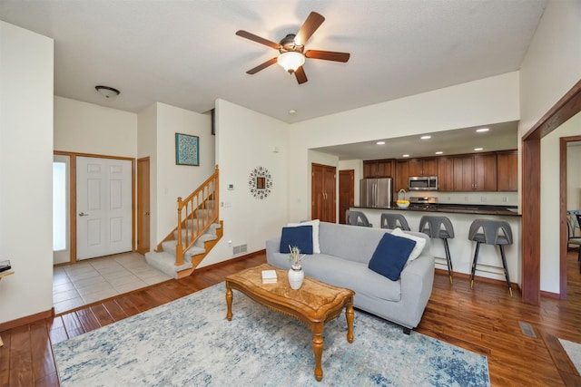 15919 Hawthorn Cir, Clive, IA 50325 - living area featuring a ceiling fan, light wood-style floors, stairway, baseboards, and recessed lighting
