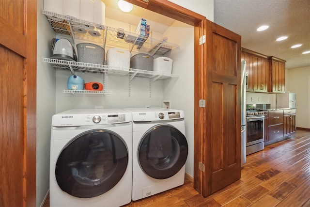 15919 Hawthorn Cir, Clive, IA 50325 - laundry room featuring dark wood-style flooring, recessed lighting, washer and dryer, and baseboards