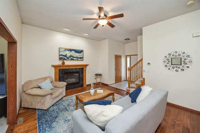 15919 Hawthorn Cir, Clive, IA 50325 - living area with a ceiling fan, wood finished floors, stairs, a fireplace, and baseboards
