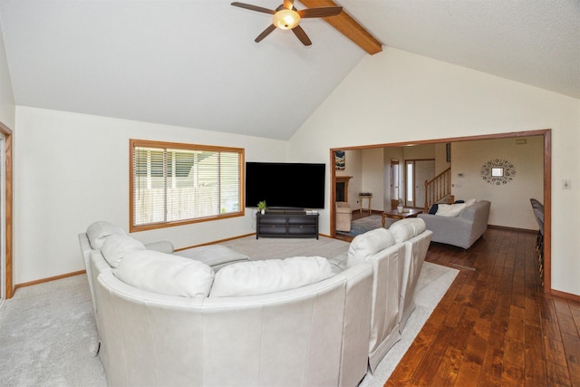 15919 Hawthorn Cir, Clive, IA 50325 - living room with a ceiling fan, beam ceiling, stairs, wood-type flooring, and high vaulted ceiling