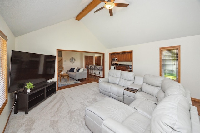 15919 Hawthorn Cir, Clive, IA 50325 - living area featuring a ceiling fan, beam ceiling, and high vaulted ceiling