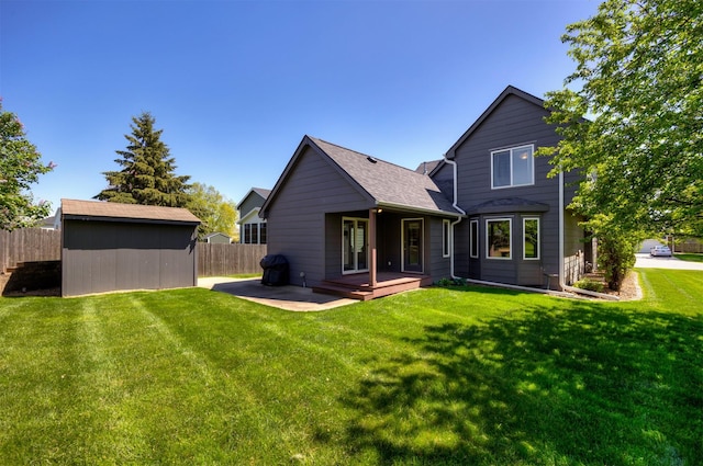 15919 Hawthorn Cir, Clive, IA 50325 - back of house with an outbuilding, a shed, and a shingled roof