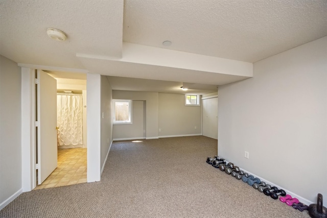15919 Hawthorn Cir, Clive, IA 50325 - basement featuring carpet floors, a textured ceiling, and baseboards