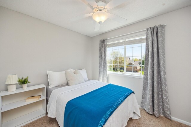 15919 Hawthorn Cir, Clive, IA 50325 - bedroom with carpet, baseboards, and a ceiling fan