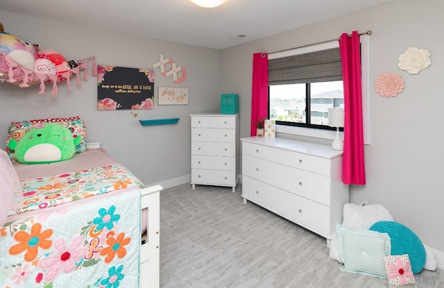 2113 NE Heritage Dr, Grimes, IA 50111 - bedroom featuring light wood-type flooring and baseboards