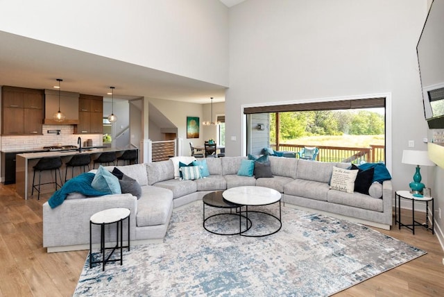2113 NE Heritage Dr, Grimes, IA 50111 - living area featuring a high ceiling, light wood-style flooring, and healthy amount of natural light