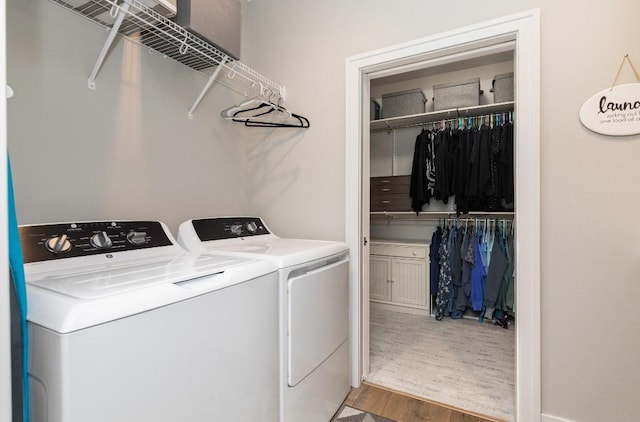 2113 NE Heritage Dr, Grimes, IA 50111 - laundry room featuring washer and clothes dryer and wood finished floors