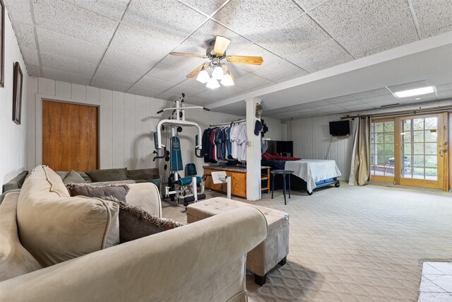 1608 W Lincoln Way, Marshalltown, IA 50158 - carpeted living room featuring a paneled ceiling and wood walls