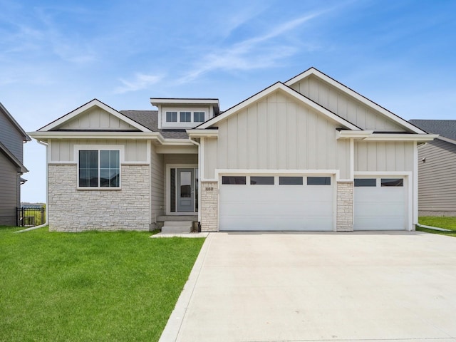460 NW Gracewood Dr, Waukee, IA 50263 - view of front of property featuring stone siding, an attached garage, board and batten siding, and concrete driveway