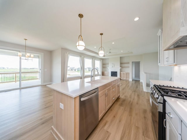 460 NW Gracewood Dr, Waukee, IA 50263 - kitchen featuring stainless steel appliances, open floor plan, a sink, healthy amount of natural light, and recessed lighting