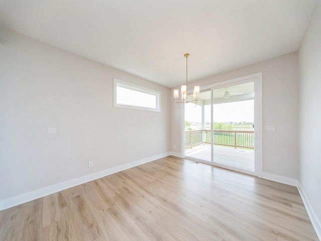 460 NW Gracewood Dr, Waukee, IA 50263 - unfurnished room featuring light wood-type flooring, a chandelier, and baseboards