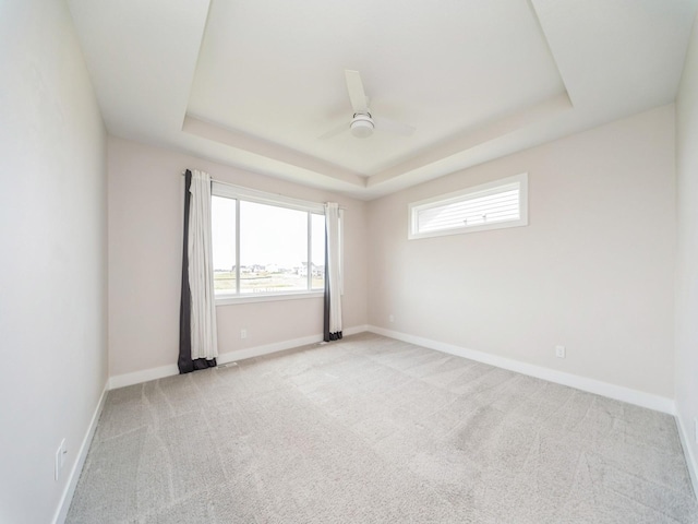 460 NW Gracewood Dr, Waukee, IA 50263 - empty room featuring a tray ceiling, carpet floors, ceiling fan, and baseboards