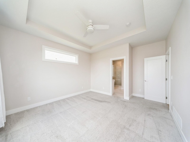 460 NW Gracewood Dr, Waukee, IA 50263 - unfurnished bedroom with a tray ceiling, carpet floors, baseboards, and a ceiling fan
