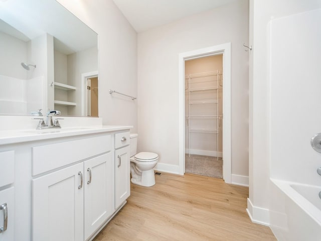 460 NW Gracewood Dr, Waukee, IA 50263 - full bath featuring toilet, wood finished floors, a spacious closet, vanity, and baseboards