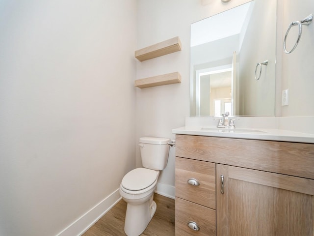 460 NW Gracewood Dr, Waukee, IA 50263 - bathroom featuring baseboards, wood finished floors, toilet, and vanity