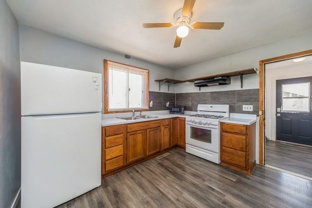 kitchen with white appliances, open shelves, a sink, and healthy amount of natural light
