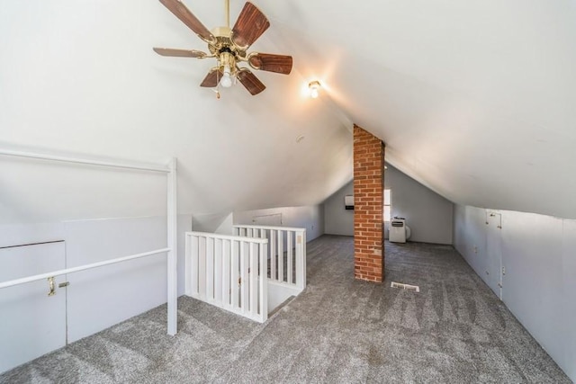 additional living space featuring carpet, vaulted ceiling, and ceiling fan