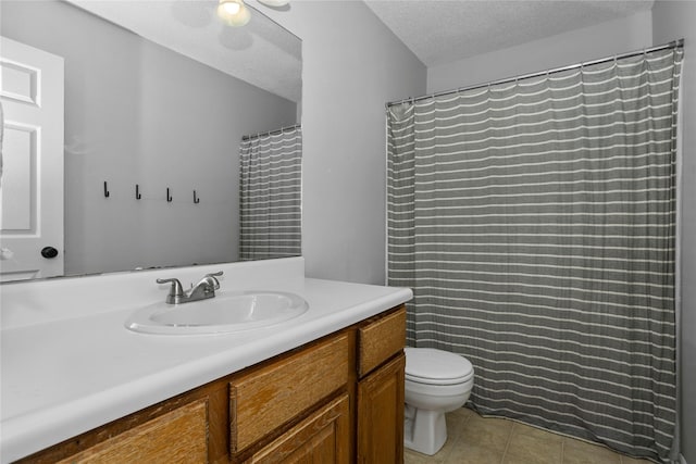 7422 Plum Dr, Urbandale, IA 50322 - full bathroom featuring vanity, toilet, tile patterned flooring, and a textured ceiling