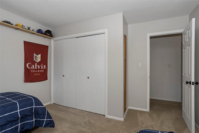 7422 Plum Dr, Urbandale, IA 50322 - bedroom featuring carpet flooring, a closet, and baseboards