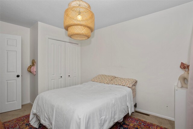 7422 Plum Dr, Urbandale, IA 50322 - bedroom featuring light colored carpet, baseboards, and a closet