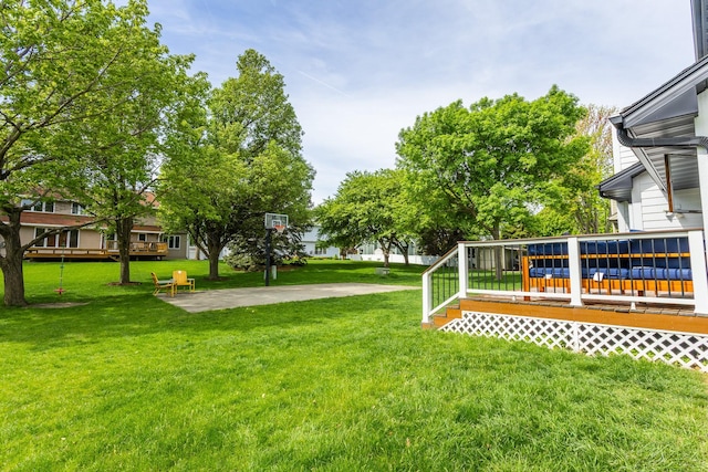 7422 Plum Dr, Urbandale, IA 50322 - view of green lawn with a deck