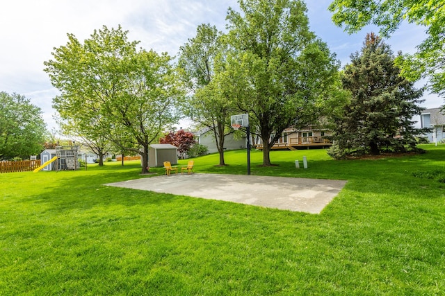 7422 Plum Dr, Urbandale, IA 50322 - view of basketball court with a playground, basketball hoop, a storage shed, and a yard