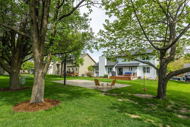 7422 Plum Dr, Urbandale, IA 50322 - view of grassy yard with a patio and a deck