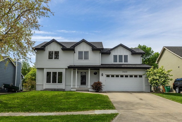7422 Plum Dr, Urbandale, IA 50322 - view of front facade featuring a front lawn, driveway, a garage, and board and batten siding