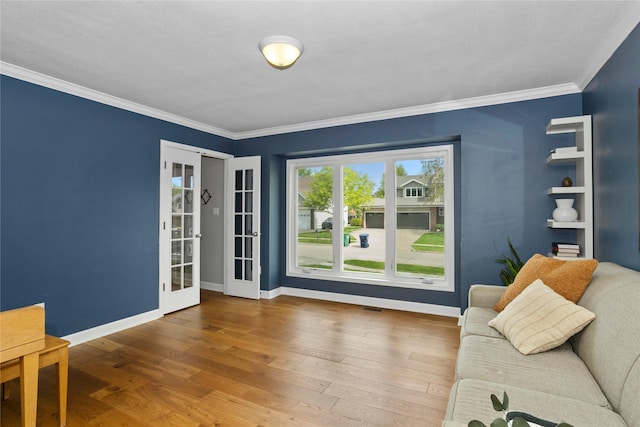 7422 Plum Dr, Urbandale, IA 50322 - living area with hardwood / wood-style floors, baseboards, ornamental molding, and french doors
