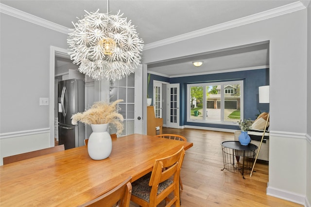 7422 Plum Dr, Urbandale, IA 50322 - dining space with a chandelier, hardwood / wood-style floors, ornamental molding, and baseboards