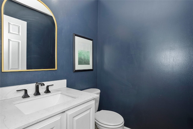 7422 Plum Dr, Urbandale, IA 50322 - bathroom featuring toilet, vanity, and baseboards