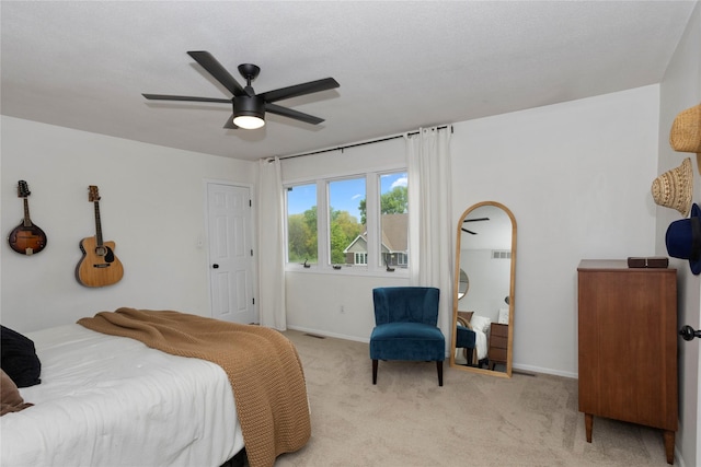 7422 Plum Dr, Urbandale, IA 50322 - bedroom featuring light carpet, baseboards, and a ceiling fan