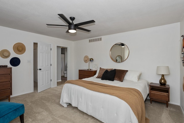 7422 Plum Dr, Urbandale, IA 50322 - bedroom with light carpet, baseboards, a ceiling fan, and ensuite bathroom