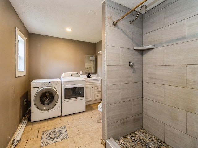 bathroom featuring separate washer and dryer, tiled shower, a baseboard radiator, toilet, and vanity