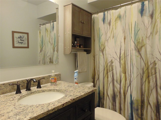 7120 Hickory Ln, Urbandale, IA 50322 - full bathroom with toilet, vanity, and a shower with curtain
