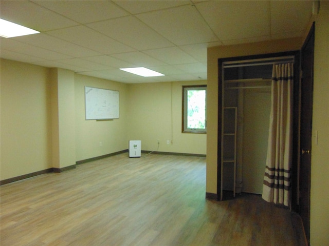 7120 Hickory Ln, Urbandale, IA 50322 - empty room with light wood-type flooring, a paneled ceiling, and baseboards