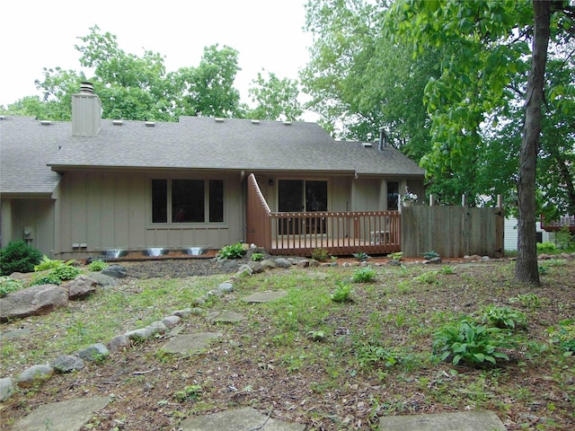 7120 Hickory Ln, Urbandale, IA 50322 - single story home featuring a chimney, a wooden deck, and a shingled roof