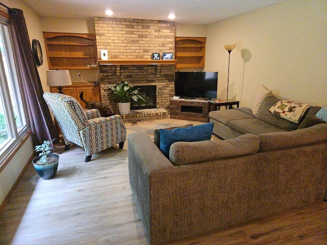 7120 Hickory Ln, Urbandale, IA 50322 - living room featuring wood finished floors, recessed lighting, a fireplace, and baseboards