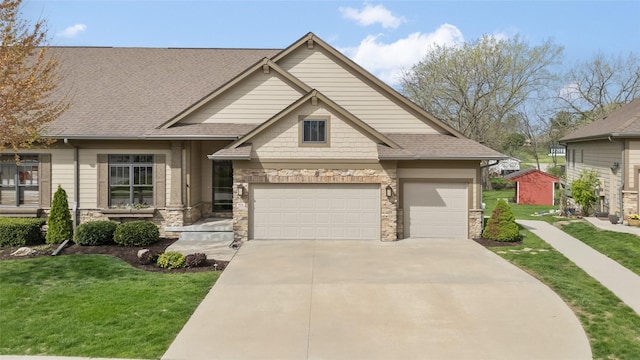 craftsman inspired home featuring stone siding, concrete driveway, a front lawn, roof with shingles, and a garage
